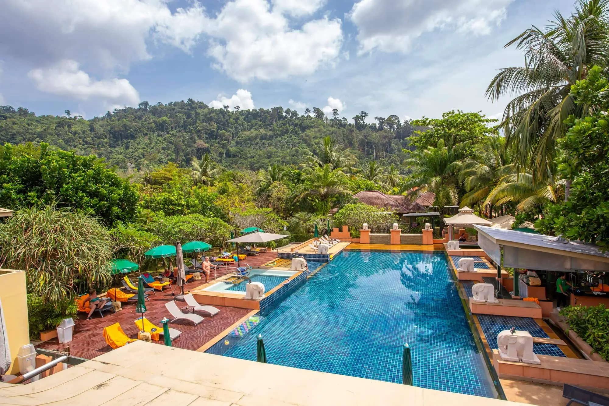 Resort swimming pool with sun loungers and tropical trees in Thailand, a typical site for on-site drinking water