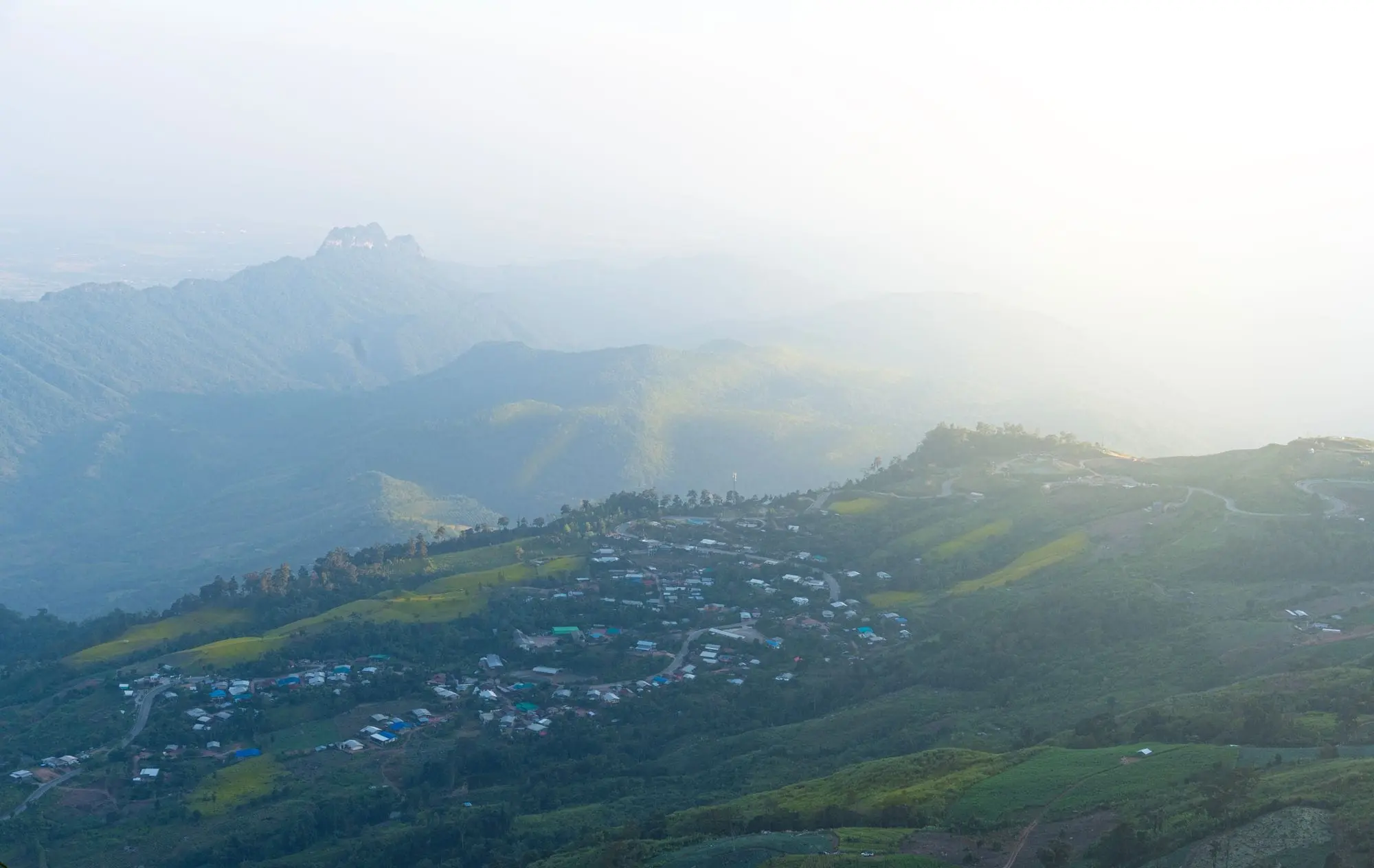 Misty mountain village at sunrise in Thailand